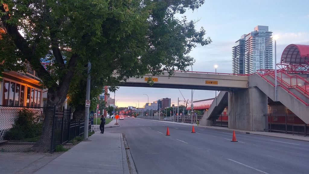 Evening on Macleod Trail by Victoria Park, with the red pedestrian bridge to the Stampede grounds